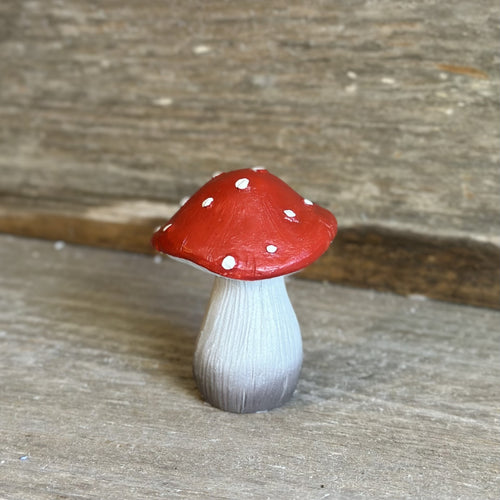 Red capped resin mushroom with white spots and white stem