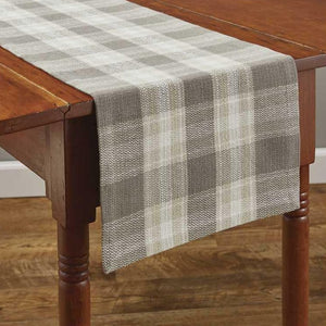 This grey plaid table runner is a wonderful accent to any farmhouse-inspired home. Use along your dining room table or even display as a mantle scarf.